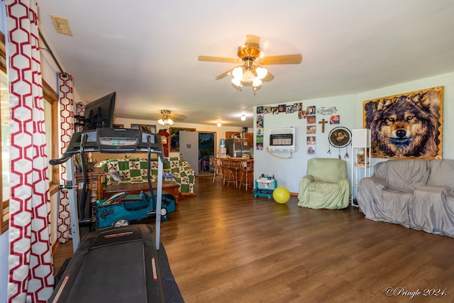 workout area with ceiling fan and dark hardwood / wood-style flooring