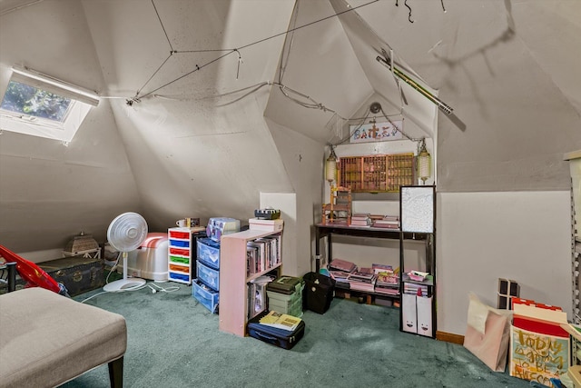 interior space with vaulted ceiling with skylight and carpet flooring