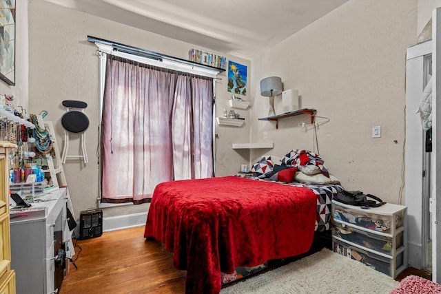 bedroom with hardwood / wood-style flooring