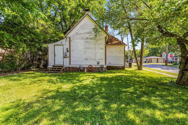 view of outbuilding with a lawn