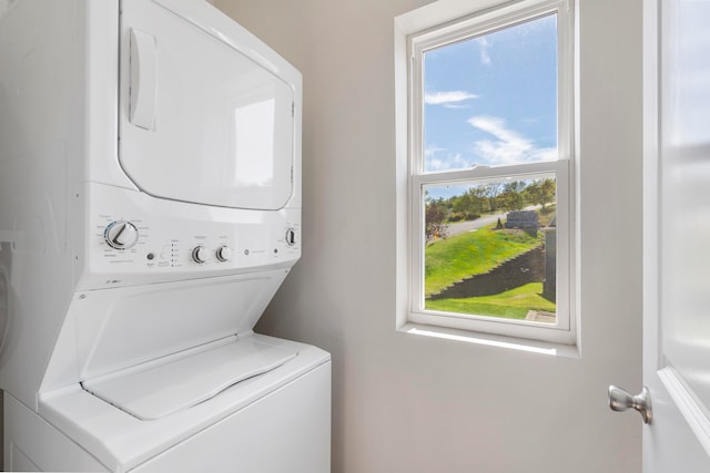 laundry room with stacked washing maching and dryer