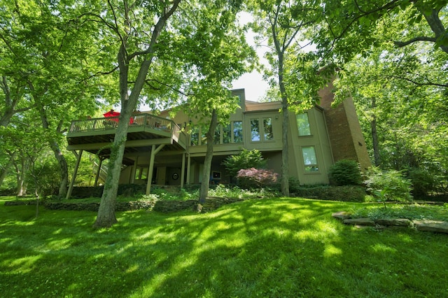 exterior space with a lawn and a wooden deck