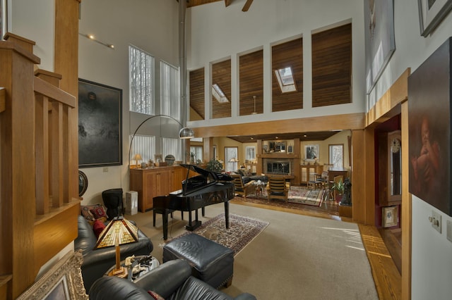 interior space featuring ceiling fan, carpet, and a towering ceiling