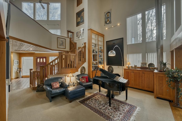 interior space with ceiling fan and a high ceiling