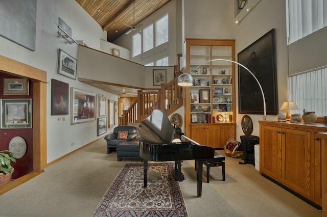 misc room featuring light carpet, a towering ceiling, and wooden ceiling