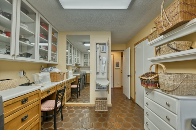 office featuring a textured ceiling and dark tile patterned flooring