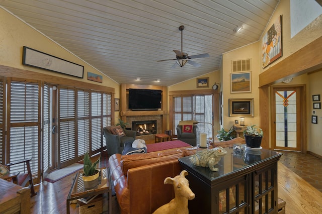 living room featuring ceiling fan, lofted ceiling, wood ceiling, and light wood-type flooring