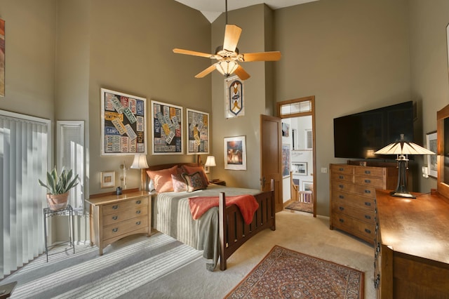 bedroom featuring high vaulted ceiling, light carpet, and ceiling fan