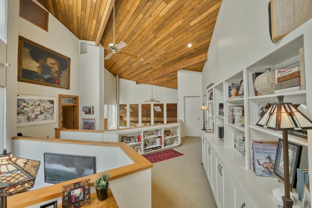 interior space with light carpet, wooden ceiling, high vaulted ceiling, and beamed ceiling