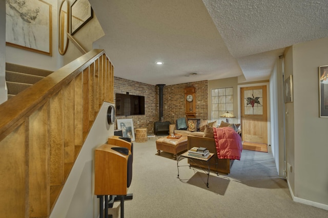 living room with a textured ceiling, a wood stove, and carpet floors