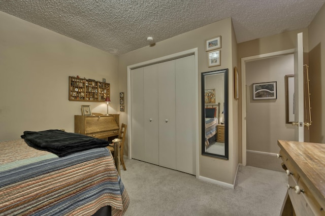 bedroom with light carpet, a closet, and a textured ceiling