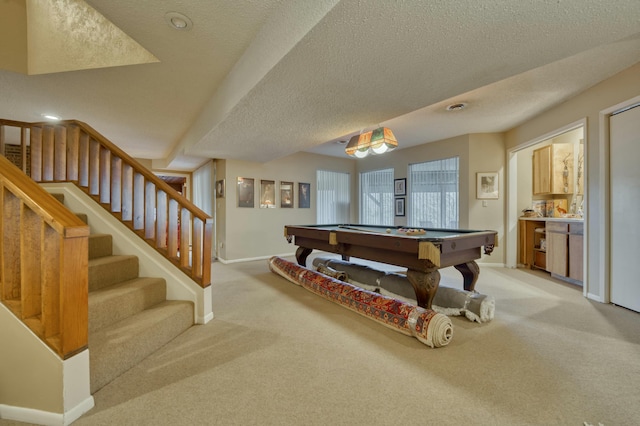 recreation room featuring light carpet, billiards, and a textured ceiling