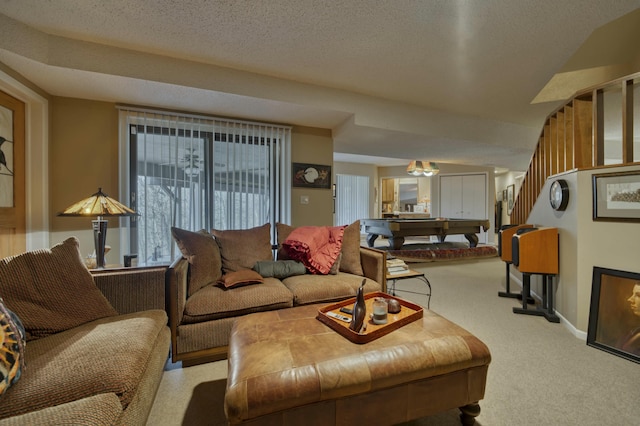 living room with a textured ceiling, billiards, and light carpet