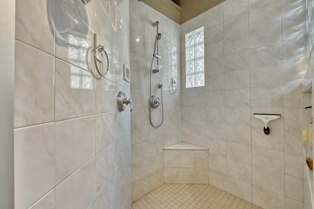 bathroom with a tile shower