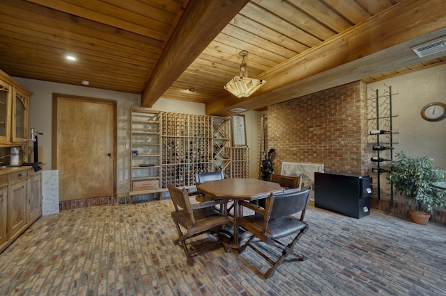 dining area featuring beam ceiling and wood ceiling