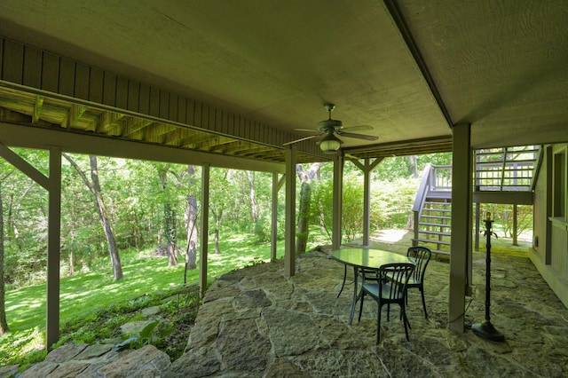 sunroom / solarium featuring ceiling fan