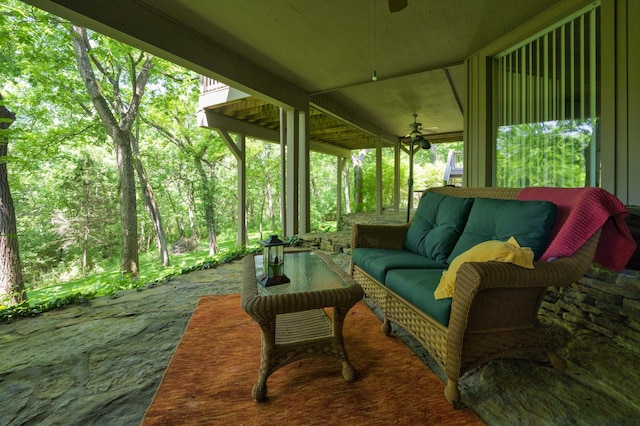 view of patio with ceiling fan and an outdoor living space