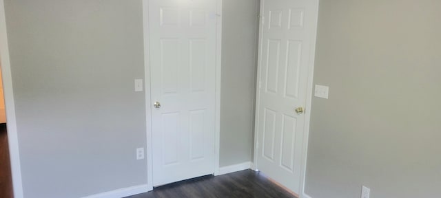 corridor featuring dark hardwood / wood-style floors