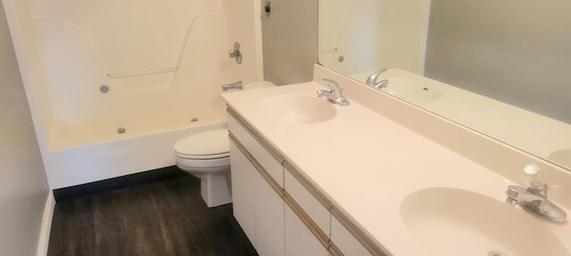 full bathroom with vanity, shower / bathtub combination, toilet, and hardwood / wood-style flooring