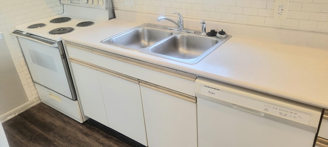 kitchen with white cabinets, sink, white appliances, tasteful backsplash, and dark wood-type flooring