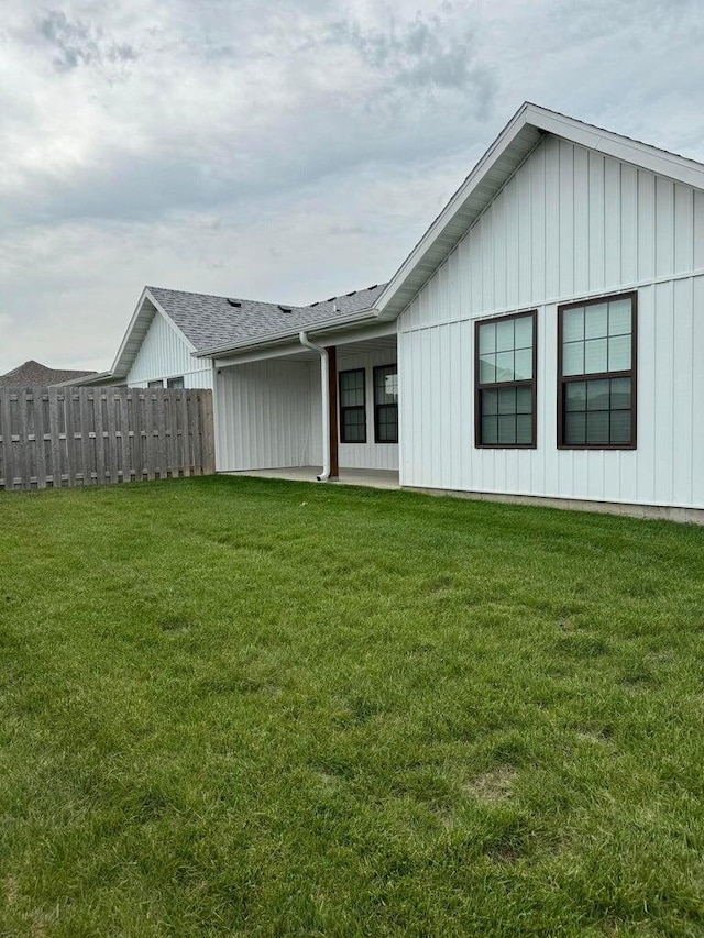 rear view of house featuring a lawn