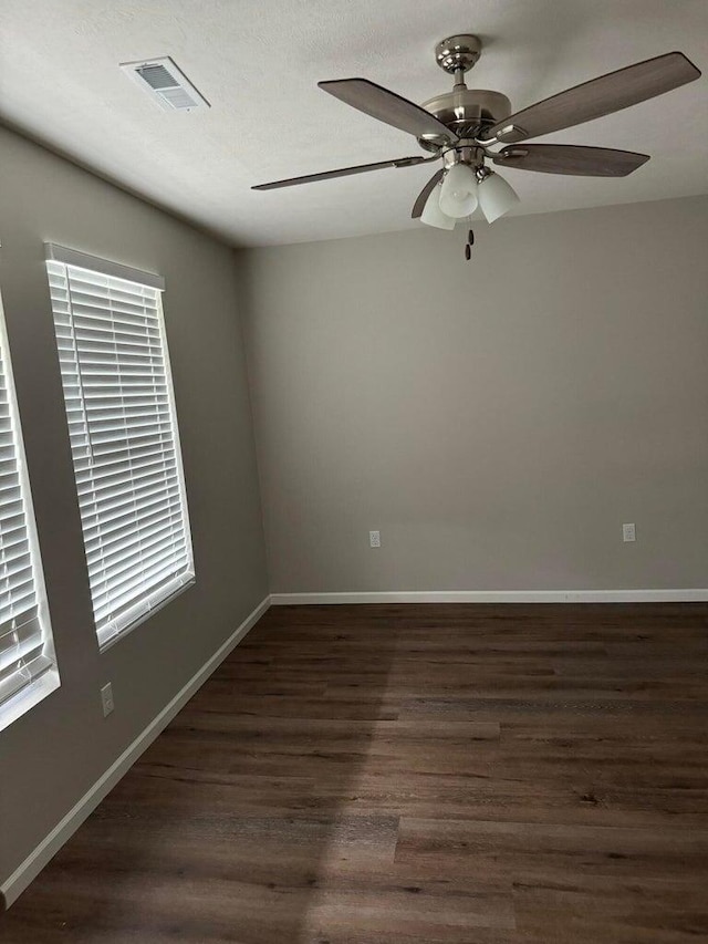 spare room with ceiling fan and dark hardwood / wood-style floors