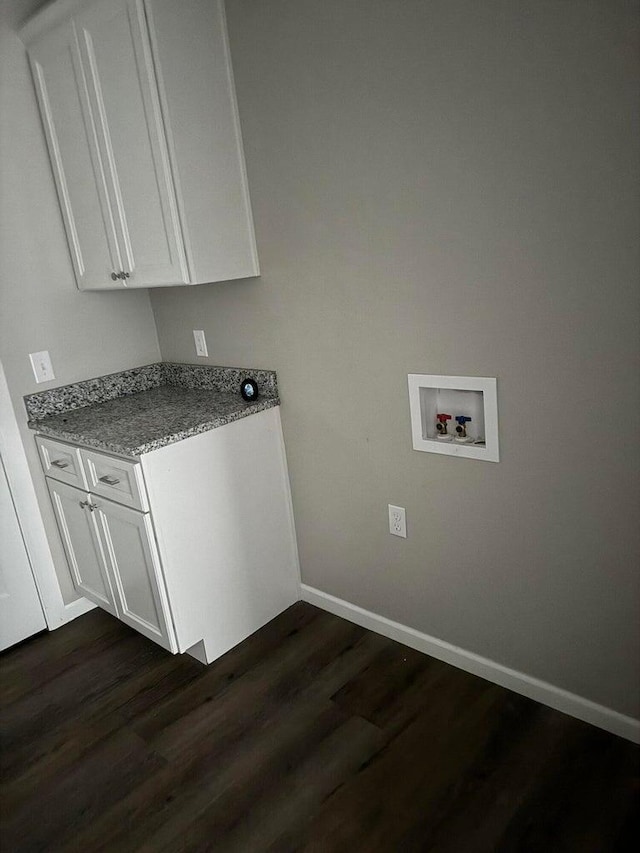 clothes washing area featuring washer hookup, cabinets, and dark wood-type flooring