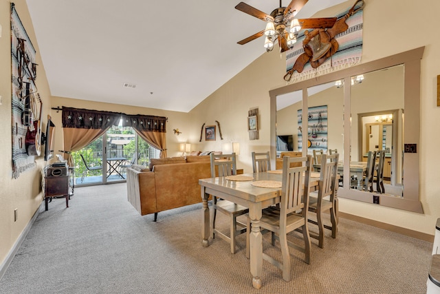 carpeted dining room featuring ceiling fan and high vaulted ceiling