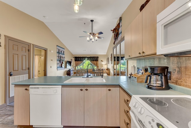 kitchen with lofted ceiling, ceiling fan, white appliances, sink, and light brown cabinetry