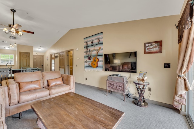 carpeted living room featuring lofted ceiling, sink, and ceiling fan