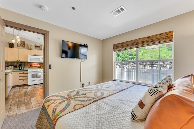 carpeted bedroom with access to exterior and vaulted ceiling