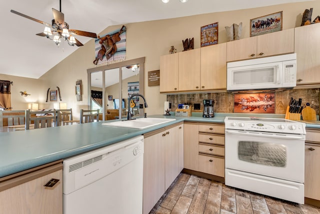 kitchen featuring ceiling fan, white appliances, wood-type flooring, vaulted ceiling, and sink