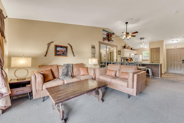 living room featuring ceiling fan, light colored carpet, and lofted ceiling