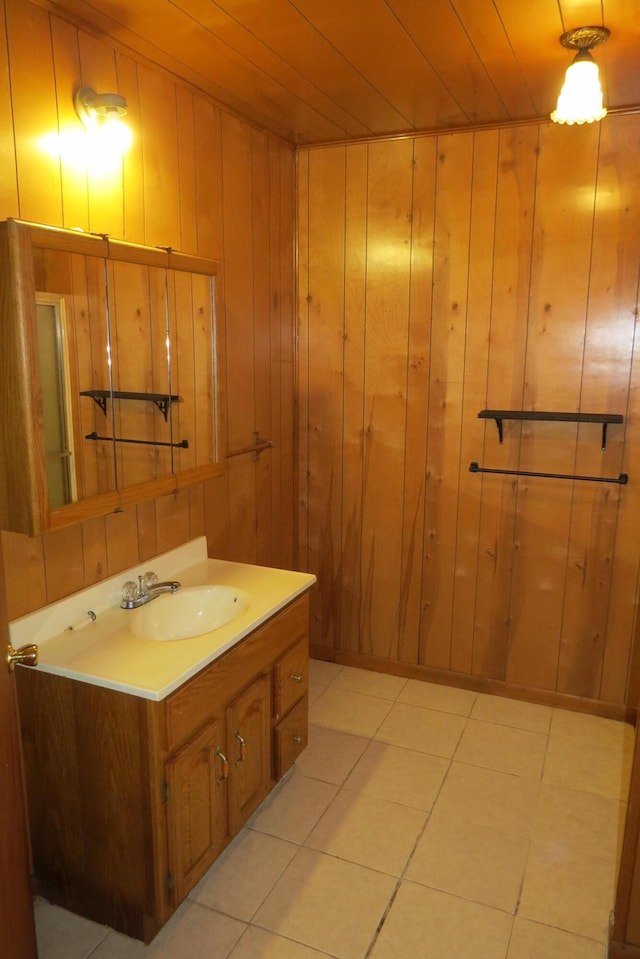 bathroom featuring tile patterned flooring, wood walls, vanity, and wood ceiling