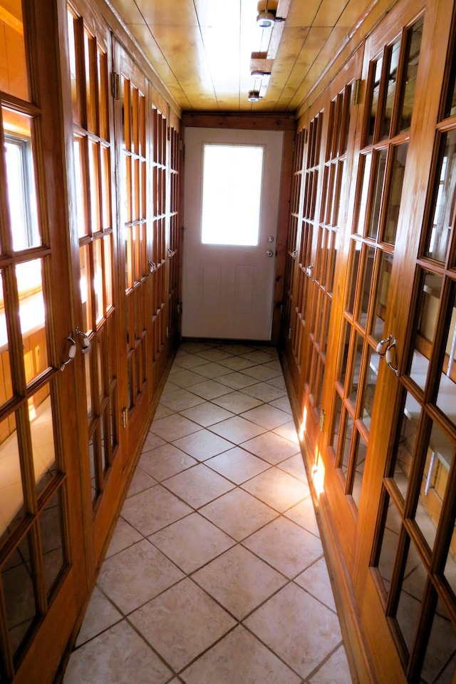 doorway to outside with tile patterned floors and french doors