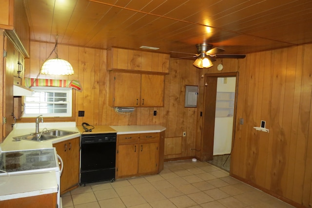 kitchen featuring hanging light fixtures, sink, black dishwasher, and wood walls