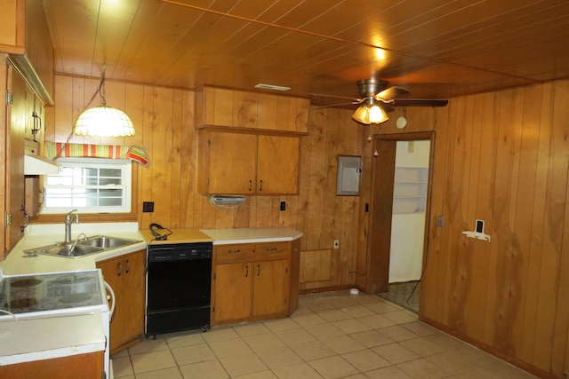 kitchen with wooden walls, black dishwasher, light countertops, and a sink