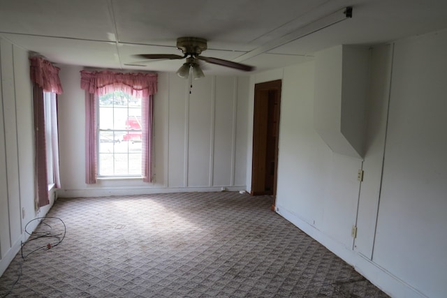 carpeted spare room with ceiling fan