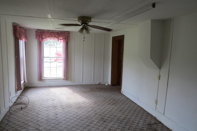 empty room featuring baseboards, carpet, and ceiling fan