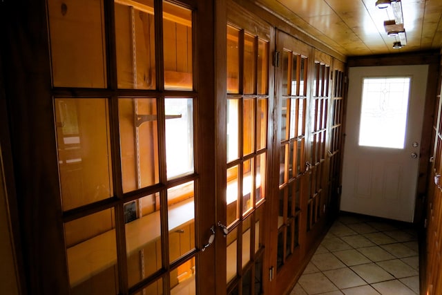 doorway to outside featuring light tile patterned flooring and french doors