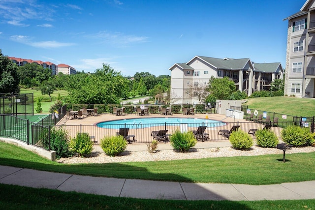 view of swimming pool featuring a patio and a lawn