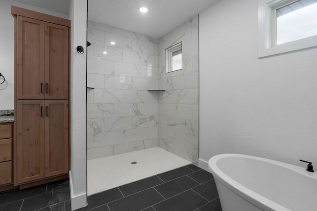 bathroom with tile patterned floors and shower with separate bathtub