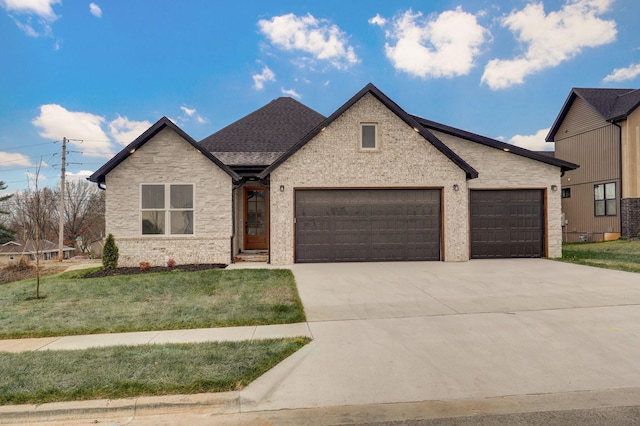 view of front of house featuring a front yard and a garage