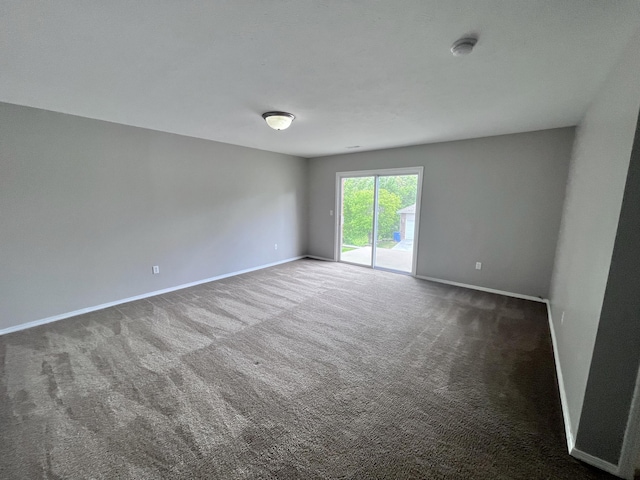 empty room featuring dark carpet