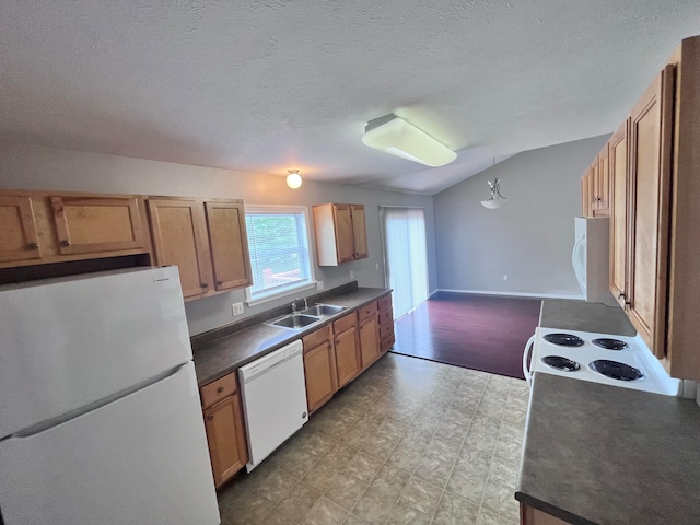 kitchen with white appliances, sink, light hardwood / wood-style floors, vaulted ceiling, and decorative light fixtures