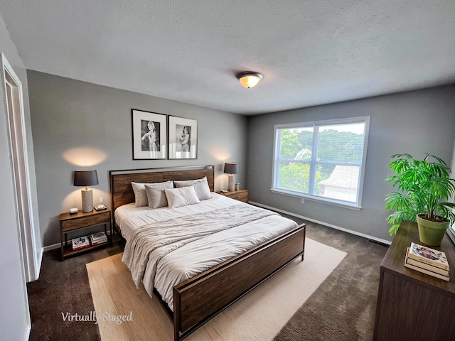 carpeted bedroom with a textured ceiling