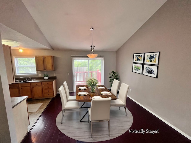 dining space featuring light hardwood / wood-style flooring and vaulted ceiling