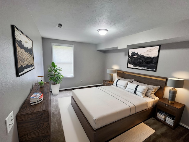 carpeted bedroom with a textured ceiling