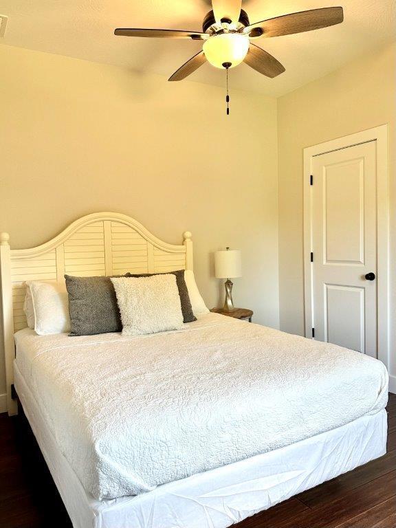 bedroom featuring ceiling fan and dark hardwood / wood-style floors