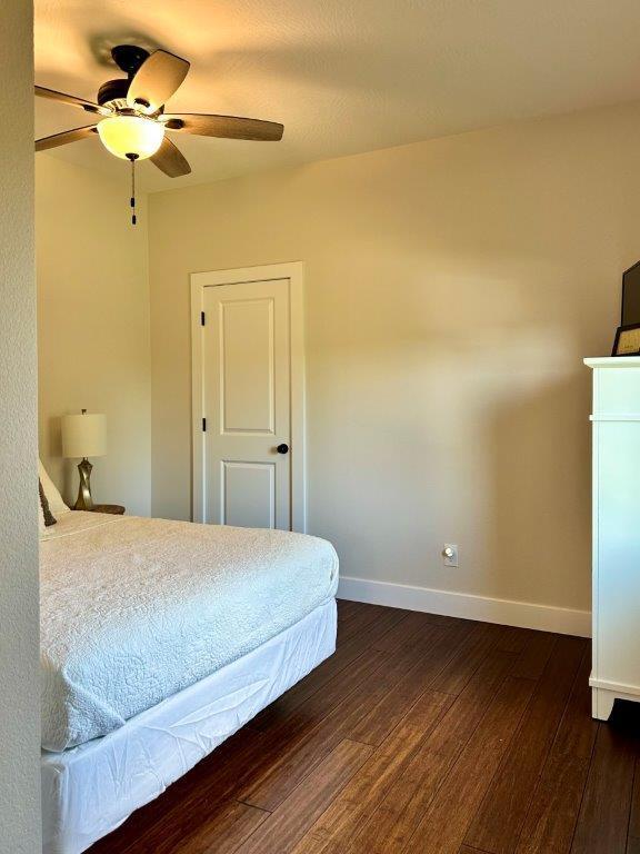 bedroom featuring dark hardwood / wood-style flooring and ceiling fan